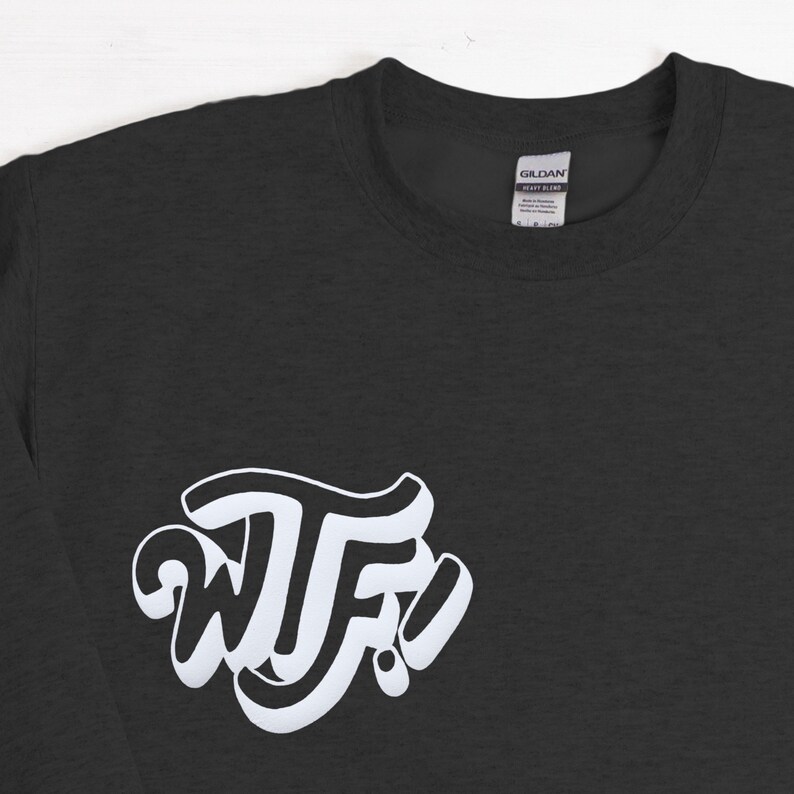 May include: A dark gray long-sleeve t-shirt with a white graphic of the letters "WTF" in a stylized font.