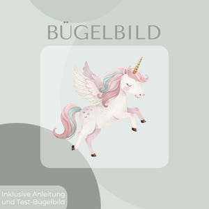 May include: A watercolor illustration of a white unicorn with pink and teal accents, a golden horn, and feathered wings. The text "BÜGELBILD" is at the top. The image is on a light gray background.
