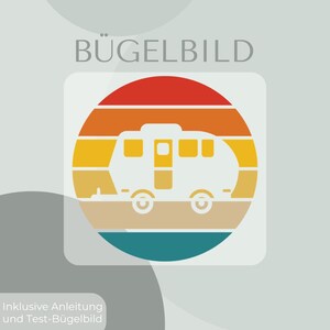 May include: A circular iron-on transfer featuring a white silhouette of a camper trailer set against a background of horizontal stripes in red, orange, yellow, and teal. The text BÜGELBILD appears at the top, with Inklusive Anleitung und Test-Bügelbild at the bottom.