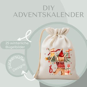 May include: A beige drawstring bag with a festive illustration of a bear carrying a Christmas tree and gifts. The bag has the text "DIY ADVENTSKALENDER" and "25 winterliche Bügelbilder".