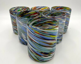 May include: Set of six colorful glass tumblers with a swirling pattern of blue, green, red, yellow, and white.