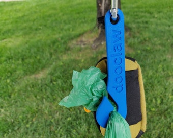 The DooClaw poop bag holder.  The dog walking accessory that you never knew you needed. Let the DooClaw carry your dog's load!