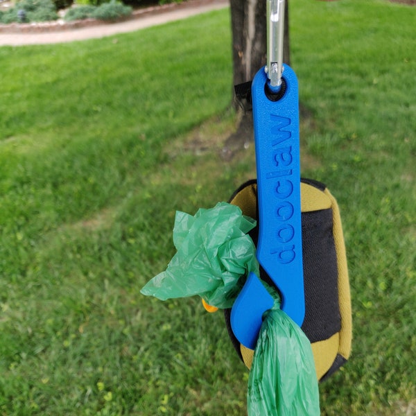 The DooClaw poop bag holder.  The dog walking accessory that you never knew you needed. Let the DooClaw carry your dog's load!