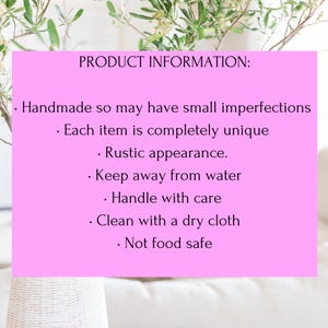May include: A pink rectangle with the text "PRODUCT INFORMATION:" and bullet points listing product details. The text includes "Handmade," "Rustic appearance," and care instructions like "Keep away from water" and "Clean with a dry cloth."