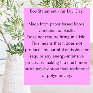May include: A bright pink rectangular sign with black text that reads: Eco Statement - Air Dry Clay: Made from paper based fibres. Contains no plastic. Does not require firing in a kiln. This means that it does not produce any harmful emissions.