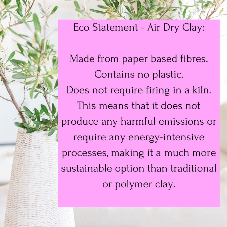 May include: A bright pink rectangular sign with black text that reads: Eco Statement - Air Dry Clay: Made from paper based fibres. Contains no plastic. Does not require firing in a kiln. This means that it does not produce any harmful emissions.