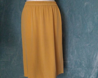 May include: A mustard yellow midi skirt with an elastic waistband.