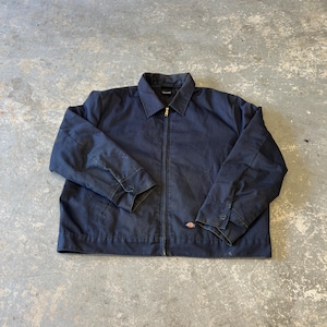 May include: Navy blue work jacket with a full-length zipper and a small logo patch. The jacket has a collared neckline, buttoned cuffs, and two front pockets. The jacket is made of a durable material.