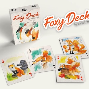 May include: A deck of playing cards titled "Foxy Deck" by Brielle Lott. The deck features watercolor illustrations of foxes. The card box and cards have a white background. The cards show foxes in various poses, with the Ace of Hearts visible.