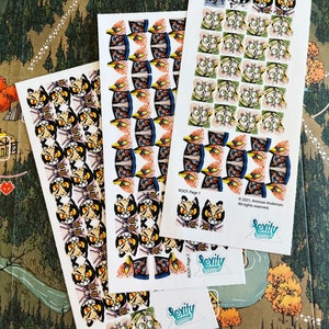 May include: Three sheets of stickers featuring colorful illustrations of cats and other creatures. The stickers are labeled "Rooti - Page 1" and "Rooti - Page 2". The stickers are from the game "Sevity Games".