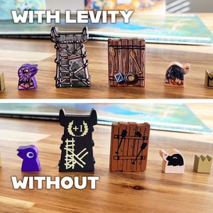 May include: Two rows of game pieces, showing the difference between playing with and without a specific ability. The top row shows a purple bird, a wooden tower, a wooden door, a brown pig, and a gold crown. The bottom row shows a gold crown, a purple bird, a black tower with a +1 symbol, a wooden door, and a white pig.