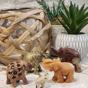Assortment of beautiful hand carved elephant figurines. Made of different types of stone. Assortment of mothers day gift