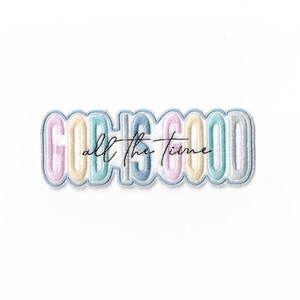 May include: Embroidered patch with the phrase "GOD IS GOOD all the time" in pastel colours. The patch features a light blue border and the words are in a playful, rounded font. The text "all the time" is in a cursive font.