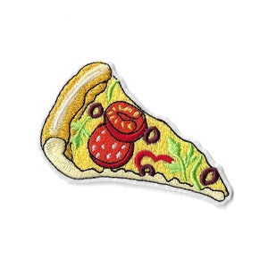 May include: An embroidered patch shaped like a slice of pizza with a thick tan crust, yellow melted cheese, red tomato slices, dark purple olive rings, and light green herb leaves, all outlined with a white border against a plain background.