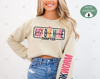 May include: A beige sweatshirt with the text "Just One More Chapter" in rainbow colors on the front and "Bookworm" in pink and blue on the sleeve.