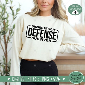 May include: A white sweatshirt with black text that reads "Dissertation Defense Survivor".