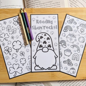 May include: Three printable bookmark designs featuring a leprechaun, shamrocks, and a pot of gold. The bookmarks are black and white and ready to be colored.