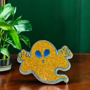 1983 Hallmark plastic orange glittery ghost pin