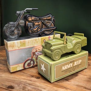 May include: A green plastic toy jeep bottle of aftershave with a white star on the box. The box reads "Avon Army Jeep Wild Country After Shave 4 fl oz".