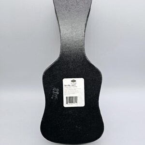 May include: Black guitar-shaped box with a white label that reads "Item No. 13077  Floor Piano Figurine".