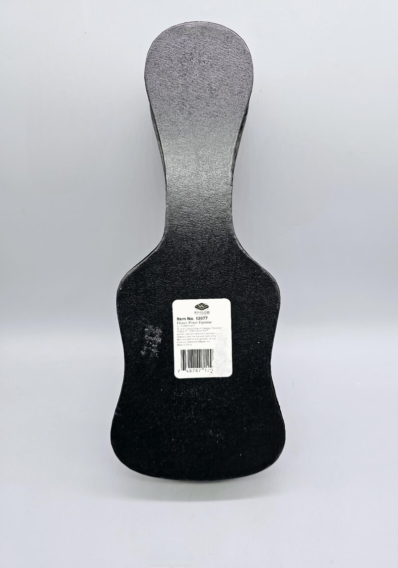May include: Black guitar-shaped box with a white label that reads "Item No. 13077  Floor Piano Figurine".