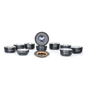 May include: A set of nine black camera lens adapters with silver accents. The adapters are arranged in a circle with a larger lens adapter in the center. The adapters are labeled with the text "M42-FX", "M42-EOS", "M42-M42", "M42-NEX", "M42-S", "M42-E", "M42-D", "M42-K", and "M42-G".