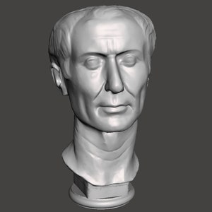 May include: A white plaster bust of a man with short hair and a serious expression. The bust is on a round base.