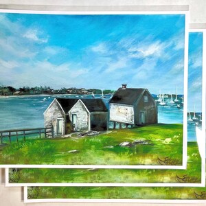May include: An original oil painting depicts a coastal scene with three weathered buildings on a grassy hill. A bright blue sky with fluffy clouds dominates the background, while sailboats dot the water. The artwork is signed in the lower right corner.