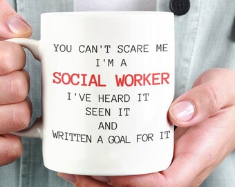 May include: White ceramic mug with a red and black text design that reads "You can't scare me I'm a social worker I've heard it seen it and written a goal for it."