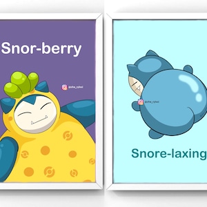May include: Two framed art prints. The left print features a cartoon character in a yellow and blue outfit with the text "Snor-berry" on a purple background. The right print shows a blue cartoon character with the text "Snore-laxing" on a light blue background.