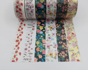 May include: Set of eight floral patterned washi tapes. The tapes feature various floral designs, including red poppies, pink flowers, and gold accents.