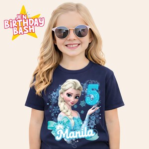 May include: Navy blue t-shirt featuring a graphic of Elsa from Frozen, the number 5, and the name "Manila". The shirt also has the text "Jen Birthday Bash" in a starburst design.