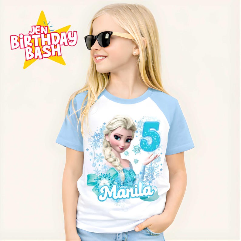 May include: White and light blue raglan style t-shirt featuring a graphic of Elsa from Frozen, the number 5, and the name "Manila". The shirt has the text "Jen Birthday Bash" in a starburst graphic.