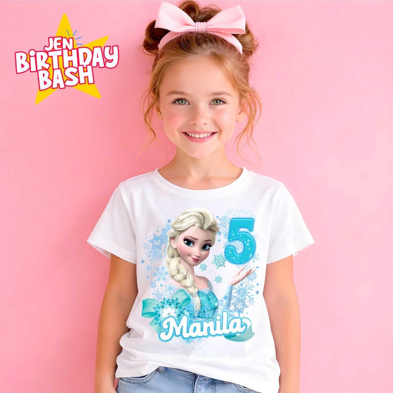 May include: White t-shirt featuring a graphic of Elsa from Frozen, with the number 5 and the name "Manila" in blue. The shirt has a light blue bow and snowflake design. The text "Jen Birthday Bash" is in the upper left corner.