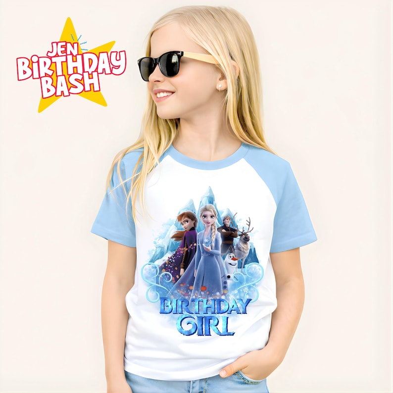 May include: A white and light blue raglan t-shirt featuring a graphic of characters from the movie Frozen, with the text "BIRTHDAY GIRL". The shirt is worn by a young girl wearing sunglasses. The text "JEN BIRTHDAY BASH" is also visible.
