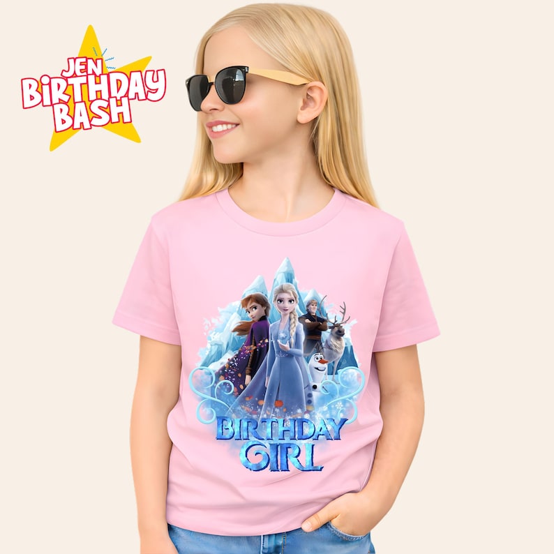 May include: A pink t-shirt featuring characters from the movie Frozen, including Elsa, Anna, Kristoff, Sven, and Olaf, with the text "BIRTHDAY GIRL". The shirt also has the text "JEN BIRTHDAY BASH" in a yellow star.