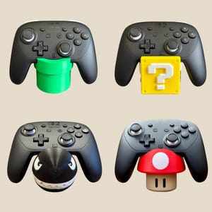 May include: Four black Switch Pro controllers, each with a different 3D-printed accessory attached. Accessories include a green pipe, a yellow question mark block, a black and white Bullet Bill, and a red and white mushroom.