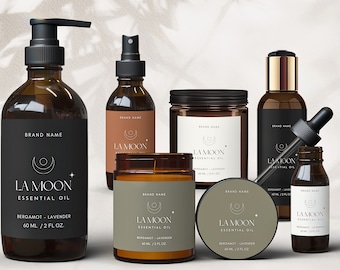 May include: A set of six amber glass bottles with black labels and gold accents. The bottles contain essential oils and candles. The labels feature a crescent moon and star design and the text "LA MOON ESSENTIAL OIL" with the scent "BERGAMOT - LAVENDER" and the volume "60 ML / 2 FL OZ."
