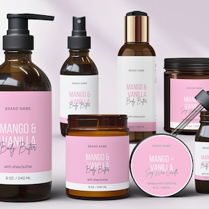 May include: A set of six brown glass bottles with pink labels and white text. The labels read "Mango & Vanilla Body Butter" and "Mango & Vanilla Soy Wax Candle". The bottles contain body butter, soy wax candles, and essential oils.