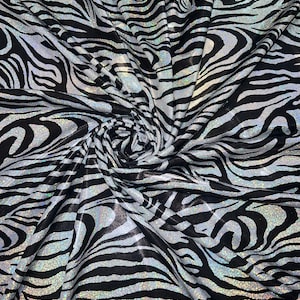 New Holographic zebra design print on metallic nylon spandex 4-Way stretch 58/60”Sold by the YD.Ships worldwide from Los Angeles CA.