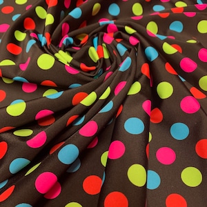 May include: Brown fabric with a polka dot pattern. The dots are in various colors, including red, pink, blue, and green.