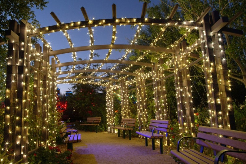 Lighted strands wrapped around posts by walk way and canopy