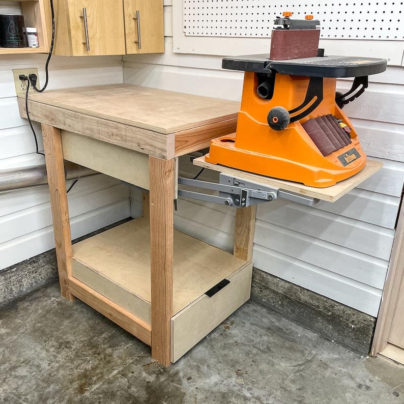 DIY workbench with benchtop sander on raised mixer lift and drawer underneath
