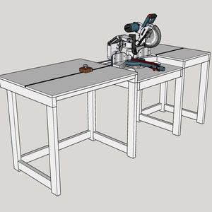 May include: A miter saw with a circular blade is mounted on a custom-built workbench. The workbench has three sections with grey tabletops and white legs. A small wooden block sits on the left table.