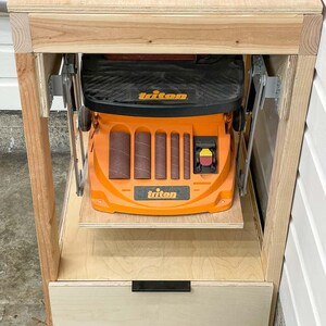 workbench with belt sander in lowered position viewed from the front