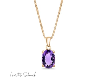 May include: A gold chain necklace with a purple oval amethyst gemstone pendant.