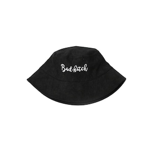 May include: Black bucket hat with the text "Bad Bitch" embroidered in white. The hat is made of a ribbed fabric and has a classic, casual style. This hat is a trendy accessory.