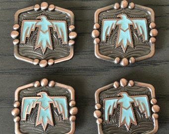 May include: Four decorative metal buttons with a turquoise blue eagle design. The buttons are hexagonal in shape with a copper-colored border and a black background.