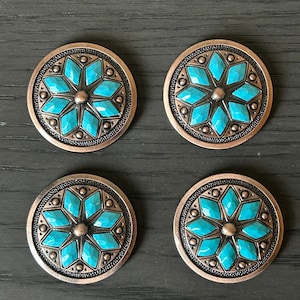 May include: Four round turquoise and copper colored metal buttons with a starburst design.