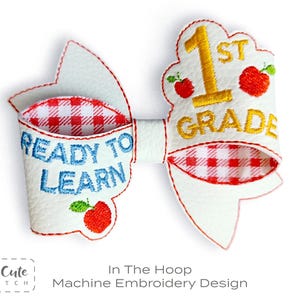 May include: White and red gingham bow with the text "READY TO LEARN" in blue and "1ST GRADE" in gold. The bow features red apple accents and is a machine embroidery design.